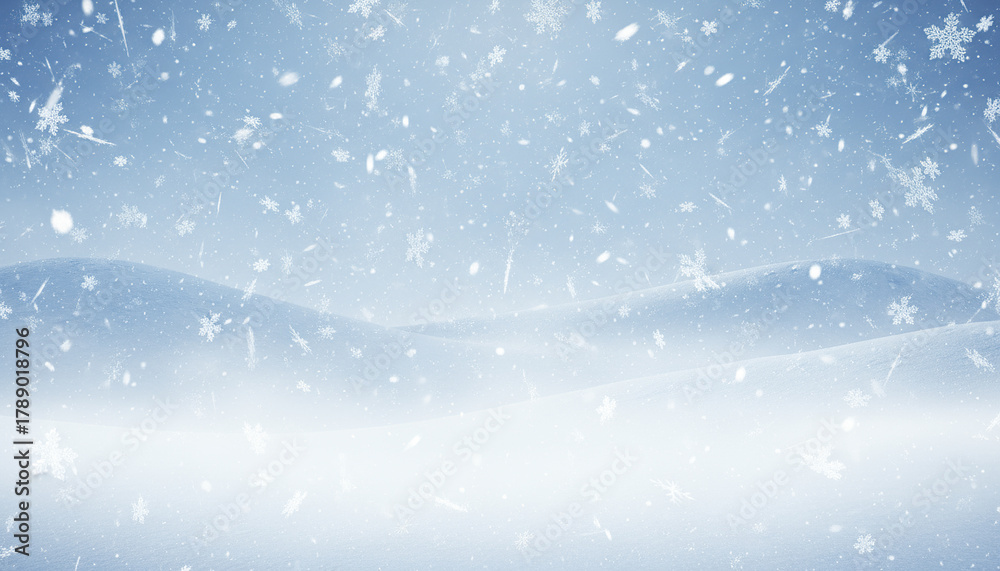 Fototapeta premium Snowfall with icy blue background and layered snowflakes creating soft misty winter scene