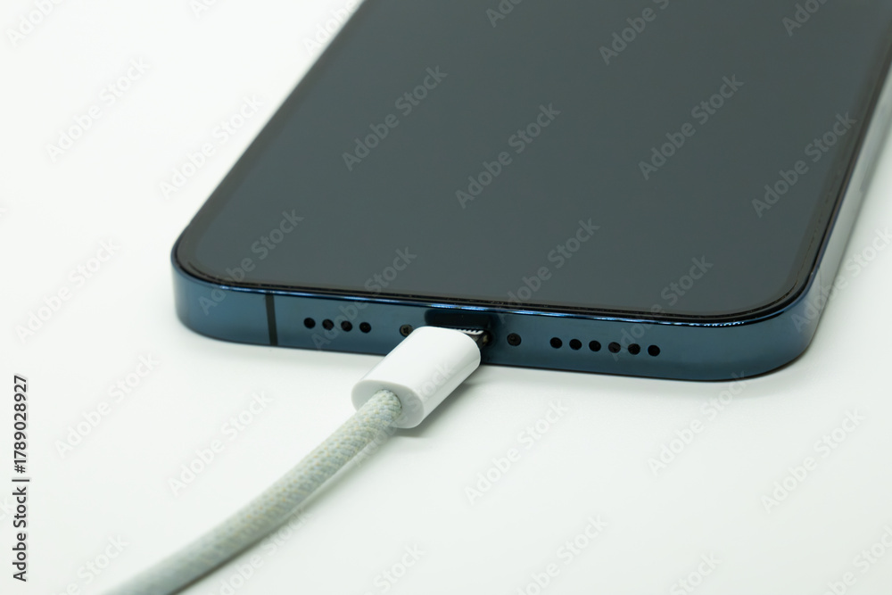 Φωτογραφία Smartphone connected to charging cable close up modern technology concept minima