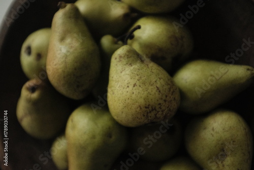 Organic farm green pears, autumn harvest. Not perfect uneven small pears organically grown without pesticides. Aesthetic artistic photo.