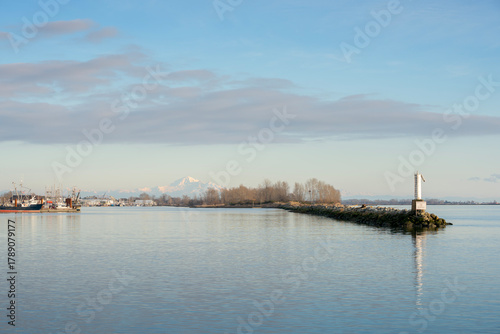Steveston Harbour Still Water and Mount Baker. The docks of Steveston Harbor on a calm day with Mount Baker in the background. British Columbia, Canada.
