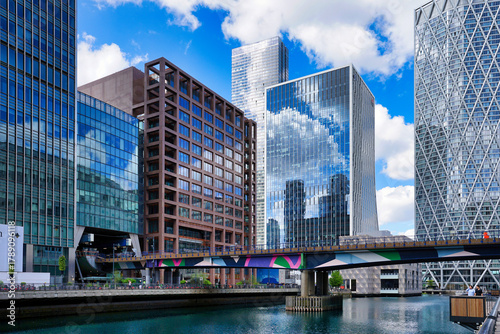 Tableau sur toile Canary Wharf, London UK, office buildings and Docklands Light Railway bridge