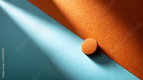 Abstract geometric art with orange wedge and elongated drop shadow on textured surface
