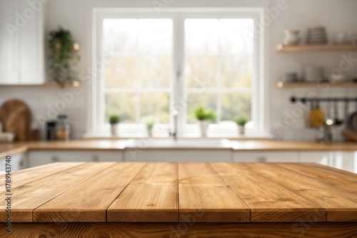 Wooden table top on defocused kitchen room and window background 