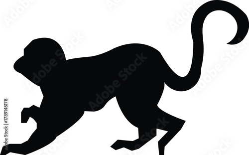 Silhouette of a playful monkey walking on all fours with curled tail