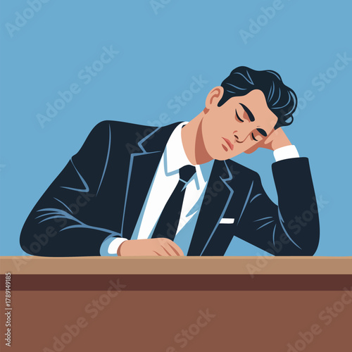 Tired man in business suit sleeps at desk putting head on arm in formal setting