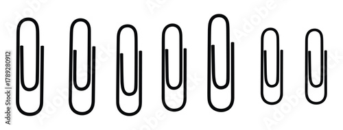 Collection of black paper clips different sizes stationary office supplies