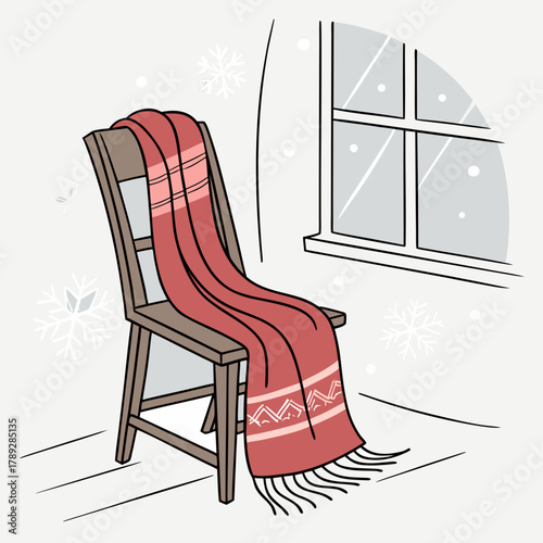 A red scarf is draped over a wooden chair near a window with snowflakes falling outside