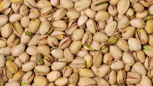 Delicious roasted pistachios in shells background