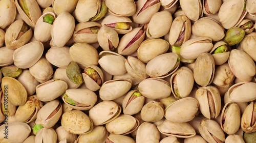 Roasted and salted pistachios background moving slowly