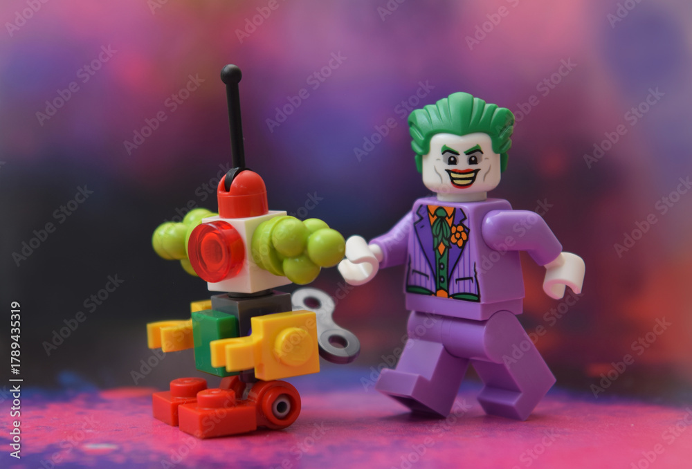 Naklejka premium Editorial illustrative image of lego minifigure of Joker in purple suit is walking.