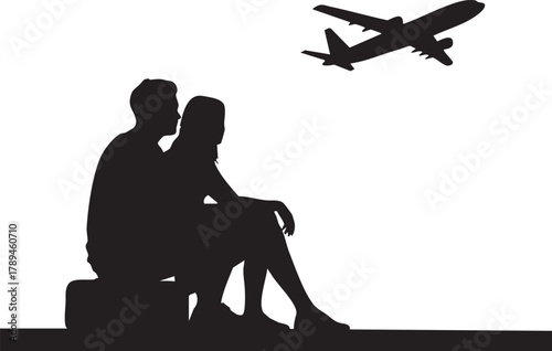 Silhouette of an affectionate couple sitting on luggage watching airplane take flight together