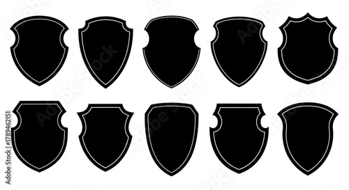 Collection of ten black silhouette heraldic shields and emblems on a white background