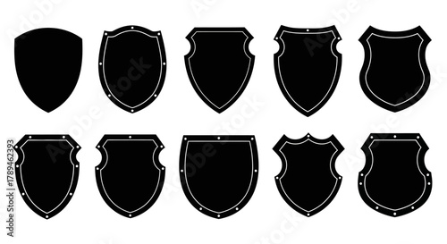 Collection of ten diverse black shield silhouettes with distressed textures and varied shapes