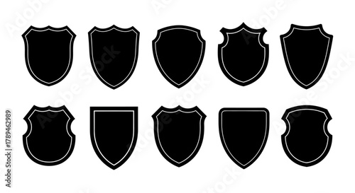 Collection of ten black heraldic shield shapes with distressed texture and varied outlines