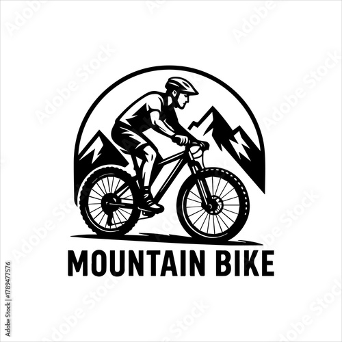 Mountain Bike Adventure Rider on a Trail with Mountain Peaks in the Background
