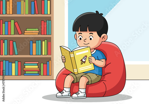 A young boy engrossed in reading a book while seated on a beanbag chair.