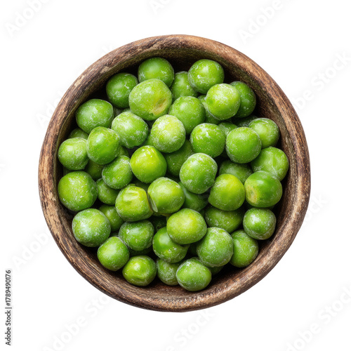 Green peas in rustic wood bowl on a black background, top-down view