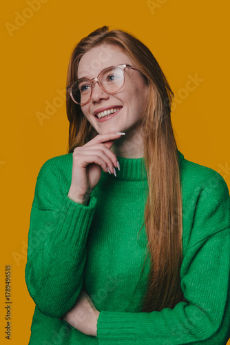 reflective redhead woman, caucasian redheaded woman in reflective pose with glasses and green