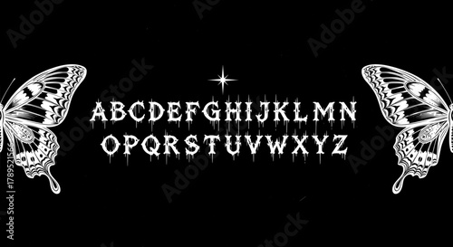 Alphabet gothic dripping font with butterfly wings