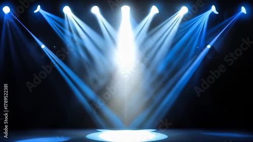 Bright Stage Lights Illuminating a Dark Venue with White and Blue Beams Creating an Atmospheric Effect