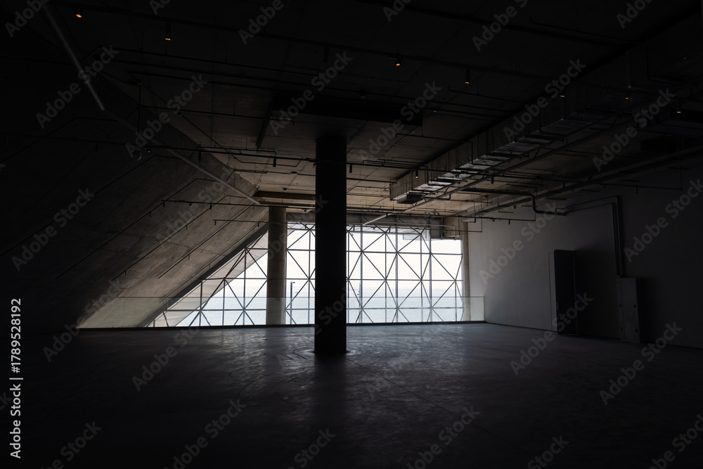 Fototapeta premium Abstract background photo featuring dark industrial interior with concrete walls