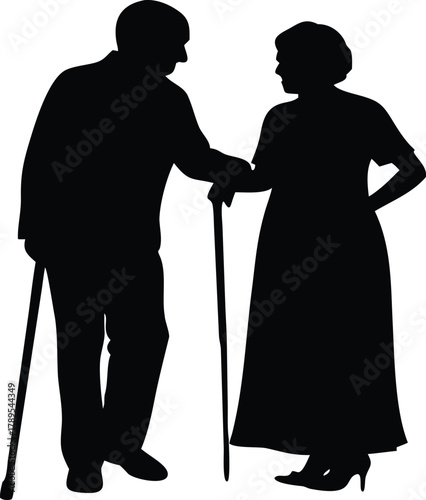 Silhouetted elderly couple standing closely together a man with a cane affection high quality
