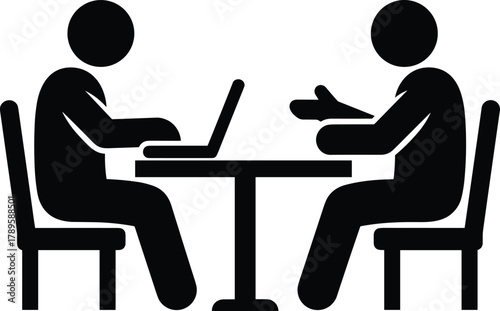 Two people sitting at a table with a laptop and one person gesturing meeting discussion computer