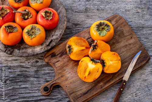 Ripe persimmon fruits in the wooden bowl. Trabzon or cennet hurması 