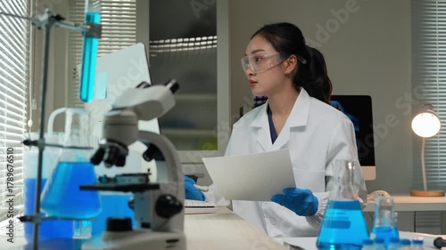 Female scientist working on computer in modern laboratory