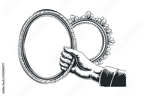 Hand holding ornate oval picture frames