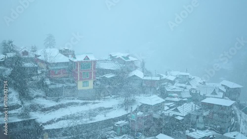 4K Slow motion shot of Sangla village covered by snow during a blizzard in winter season at Himachal Pradesh, India. Houses covered by snow during snowstorm in the winter season. Winter background.