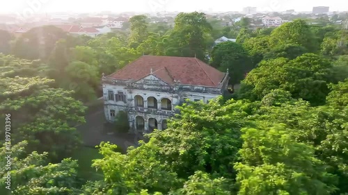 Wallpaper Mural Old colonial building surrounded by tropical greenery at golden hour, cinematic 4K drone footage Torontodigital.ca