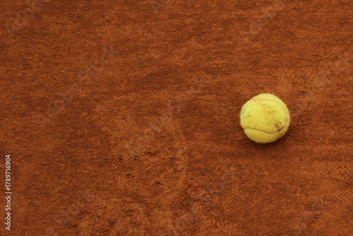 Tennis Ball on Clay Court – Focus, Stillness and Game Preparation Concept