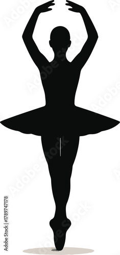 Black silhouette of a ballerina in a tutu on pointe