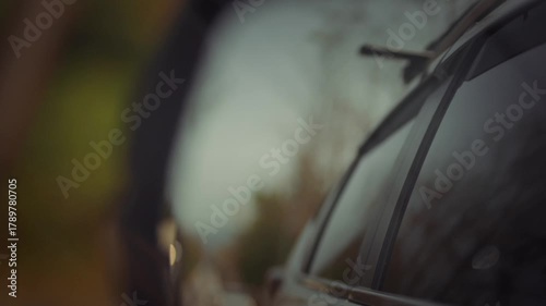 A blurred view of the car's rear view mirror.