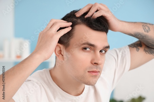 Young man with dandruff at ...