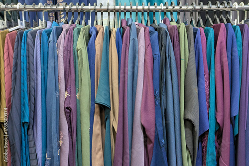 Mix colors Traditional Arabic abayas and clothing are displayed for sale at a cloth store in Souq Waqif, featuring intricate designs and cultural elegance.