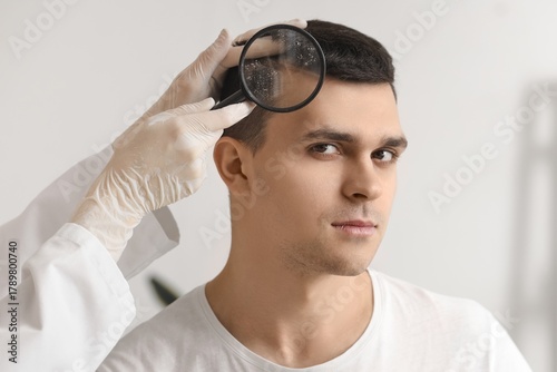 Trichologist examining scal...