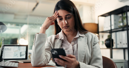 Business, woman or stress with phone notification for financial loss, trading mistake or debt at night. Trader, smartphone and headache in office for stock market crash, investment fail and pressure
