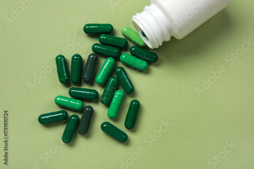 Jar with scattered pills on...