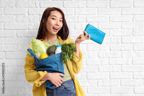 Young Asian woman with blue...