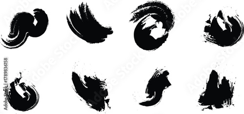 Collection of eight abstract black ink brush strokes and splatters on a white background