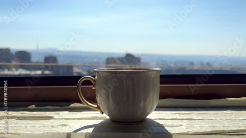 Backlight illuminate sun shine close-up steaming hot tea cup, slow motion. Concept Hot ceramic white coffee cup with smoke Hot Coffee Drink. High quality 4k