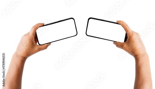 Two hands holding two cell phones, one of which is a flip phone