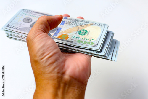 Foto Male hand with fan of dollar banknotes