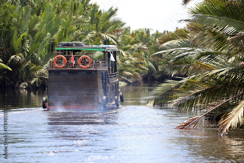 The klotok houseboat is a traditional wooden boat complete with a bed, kitchen and bathroom for cruising along the Sekonyer River, Tanjung Puting National Park, Kalimantan, Indonesia.