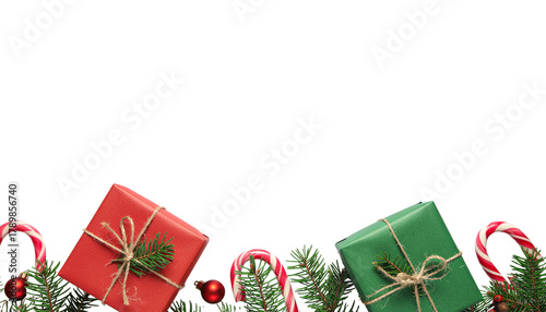 Christmas gifts in red and green wrapped with twine, surrounded by pine branches and candy canes, studio shot on white