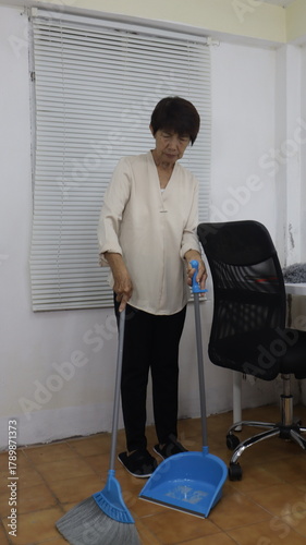 women are cleaning an office together.white office environment, showing teamwork and attention to cleanliness in the workplace.