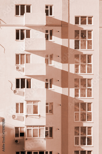 The facade of a multi-storey air-conditioned building in the colors of 2025 mocha mousse. Architectural elements of residential buildings. Beautiful pattern. Exterior elements. Abstract background