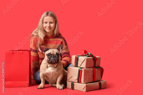 Cute girl with French bulld...